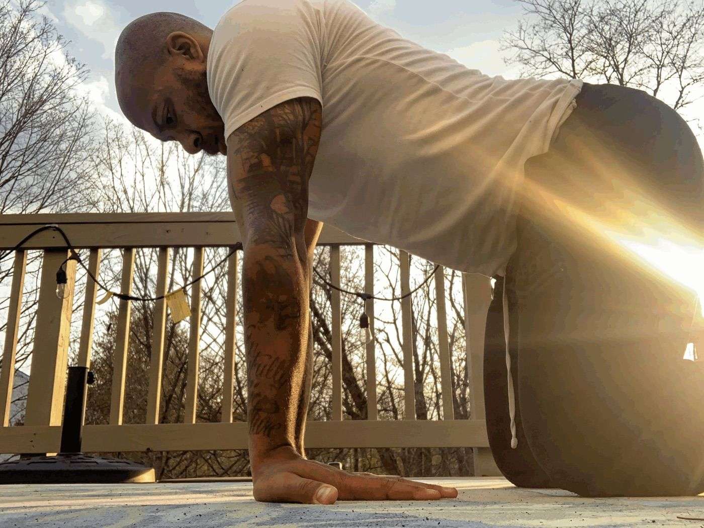 Antoine Butler holding a quadruped position on a sunlit deck